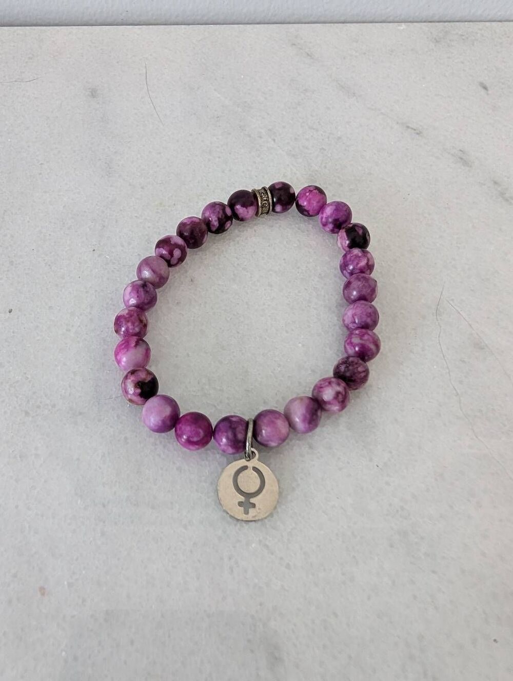 Female Symbol Charm on Purple Beaded Bracelet